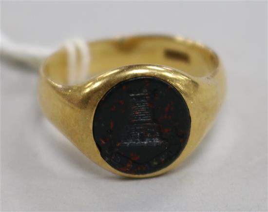 An early 20th century 18ct gold and bloodstone signet ring with carved turret matrix, size R.
